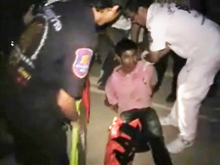 Methani Fusarikit is treated by paramedics before being taken into custody by Banglamung Police, Wednesday, March 9.